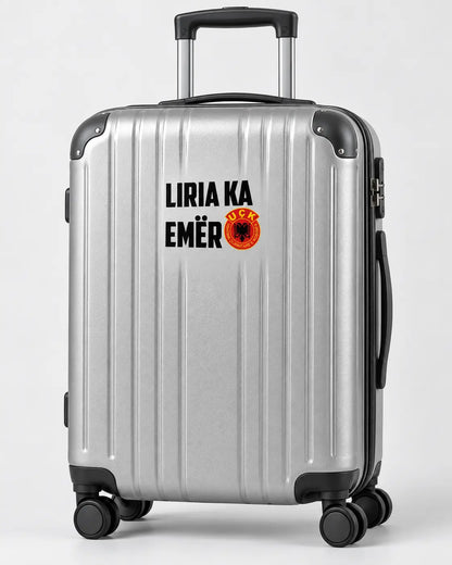 Autocollant Liria Ka Emër noir sur une valise rigide argentée
