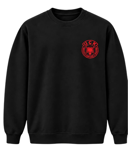 Front of the black Jo në emrin tim sweatshirt with the red UÇK emblem on the left chest