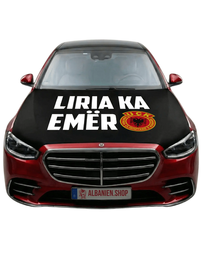 Schwarze UÇK Motorhaubenflagge auf rotem Auto montiert, mit weißem Text "Liria ka emër" und UÇK Wappen für Autokorso